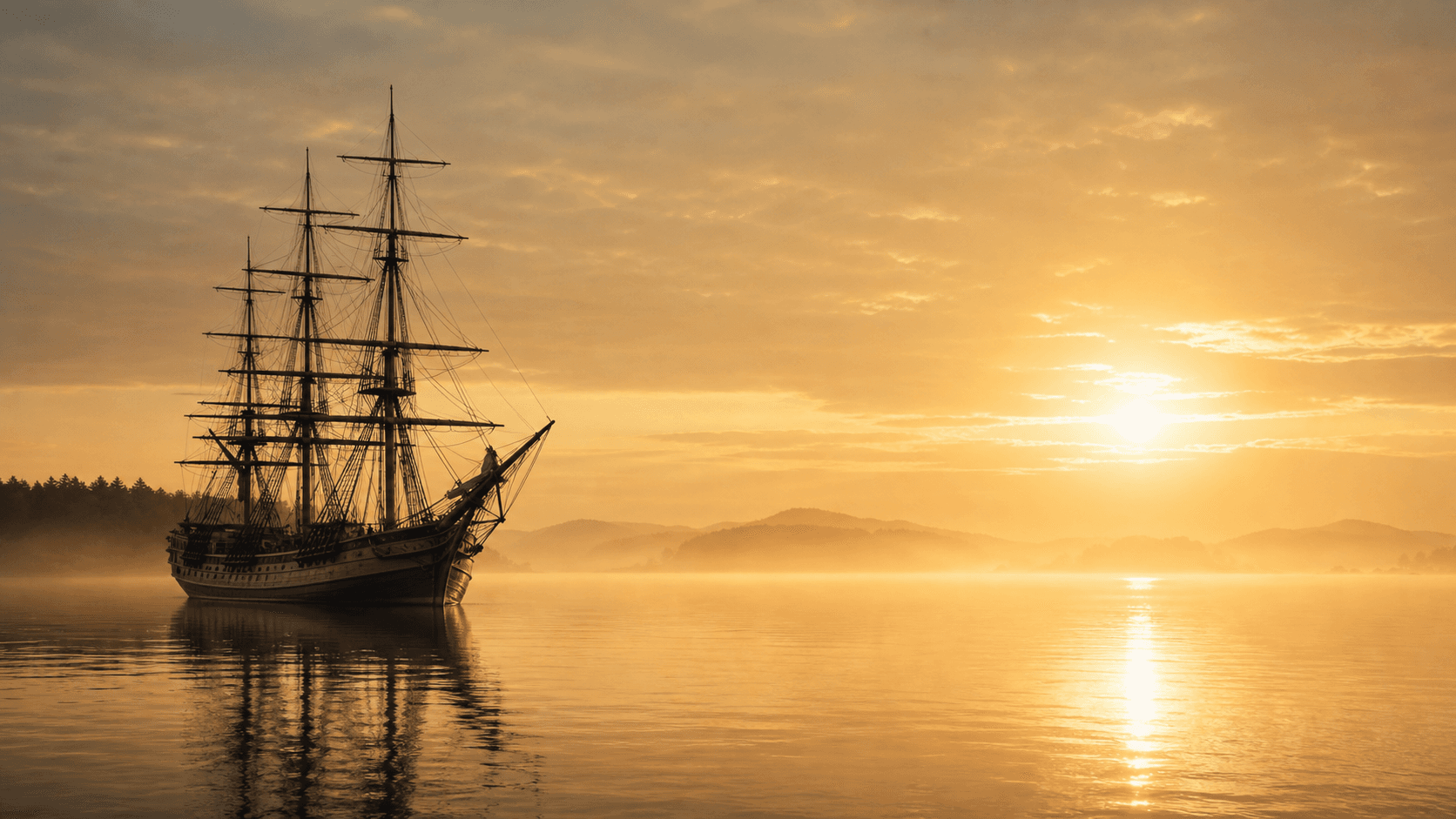 A vintage sailing ship on calm golden water at sunrise.
